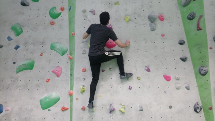 A man climbs a wall.