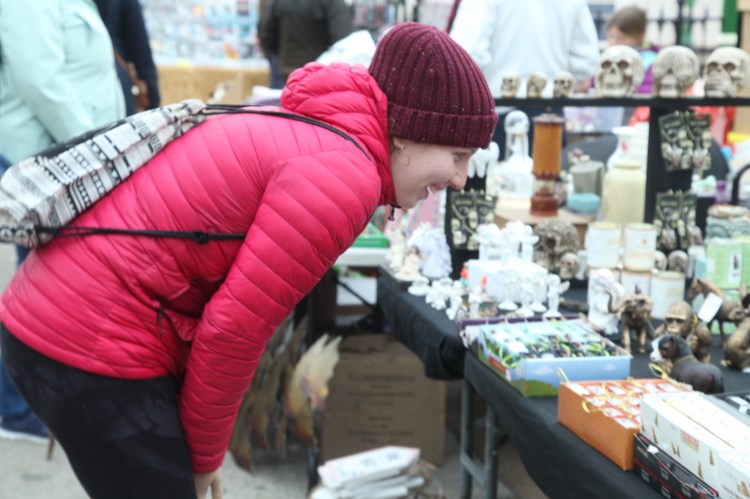 A woman looks at antiques.