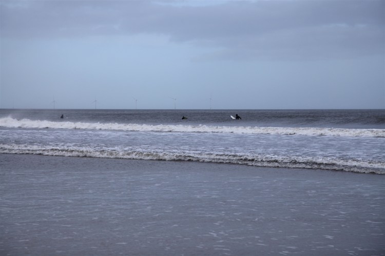 Surfers at Tynemouth wating for a wave.