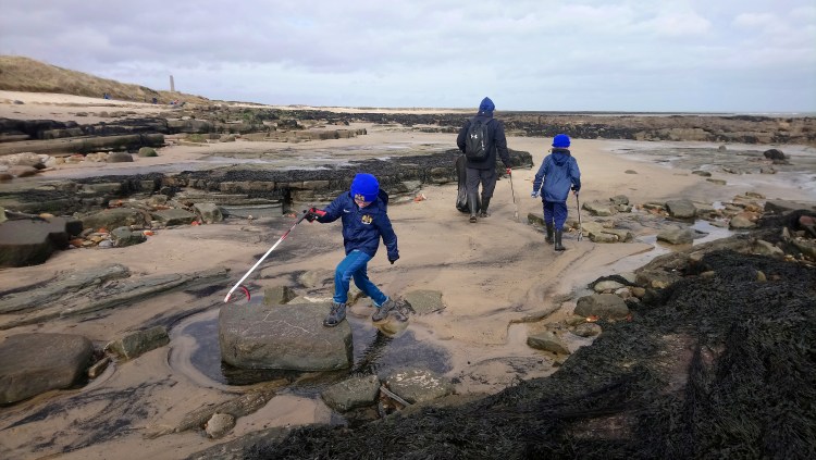 Boys helping at a beach clean